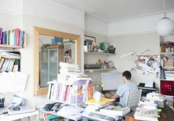 creative professional sits at computer in corner of office