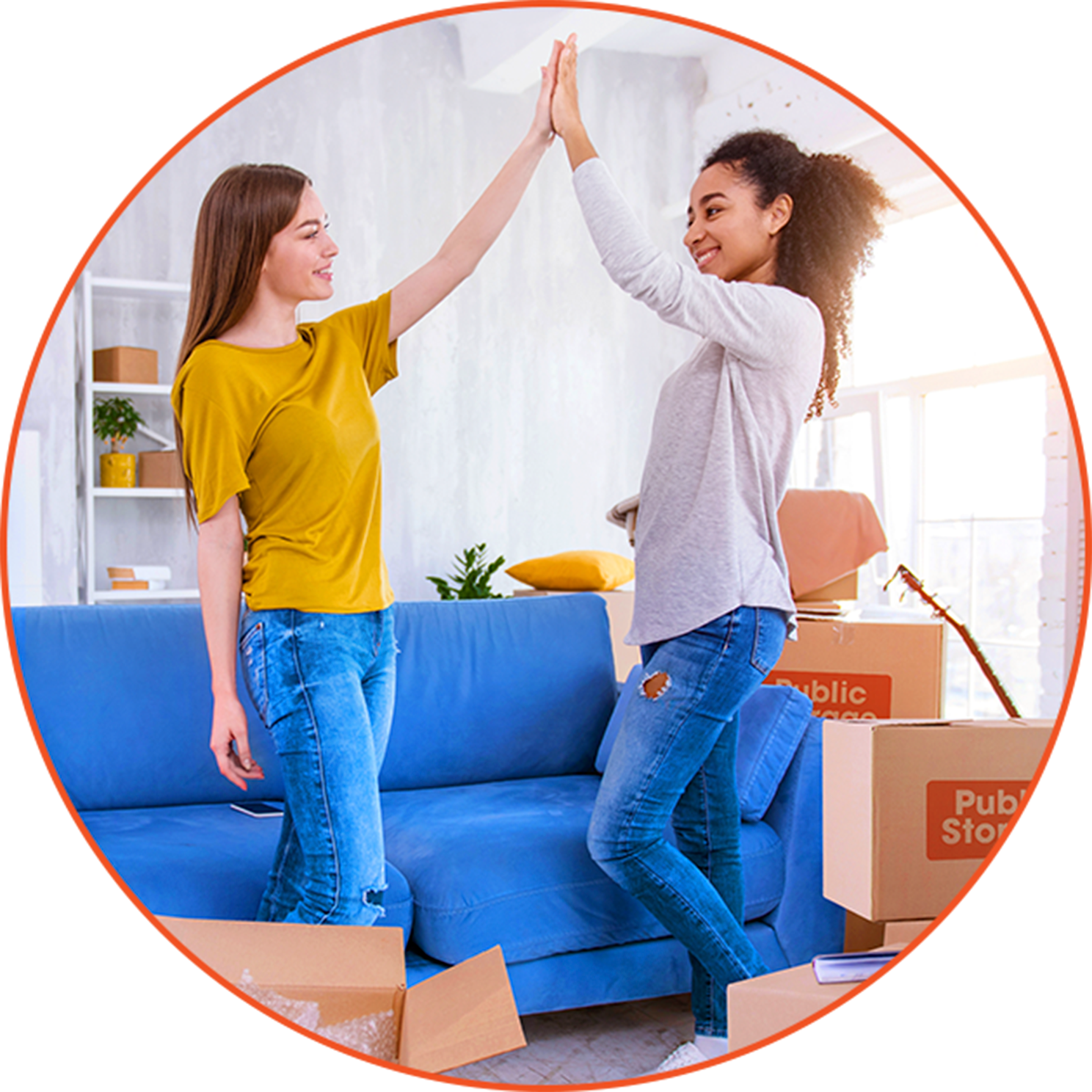 Two young women standing in a living room doing a high-five