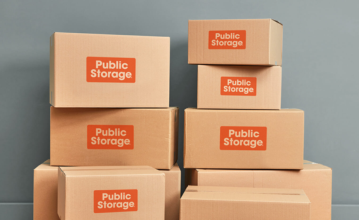 several stacked cardboard boxes displaying public storage canada logo