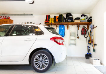 White car parked inside a neat, tidy home garage